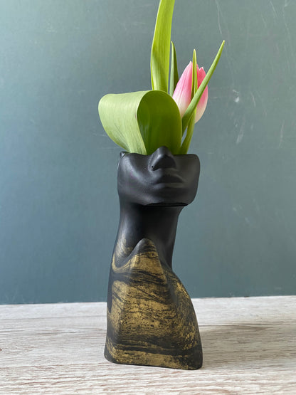 Woman half face stone vase