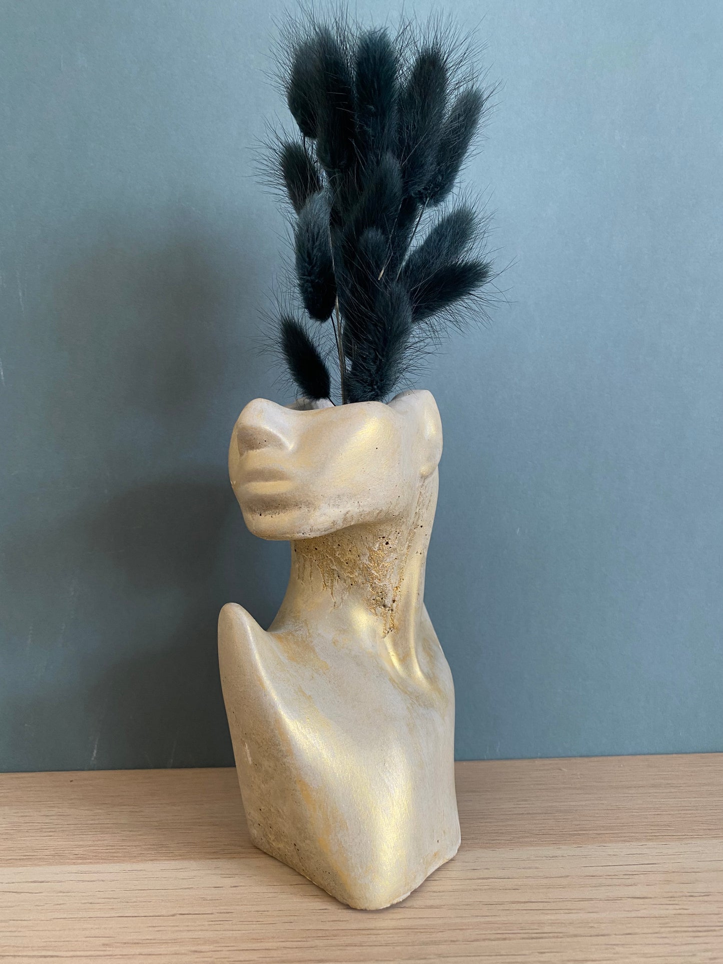 Woman half face stone vase