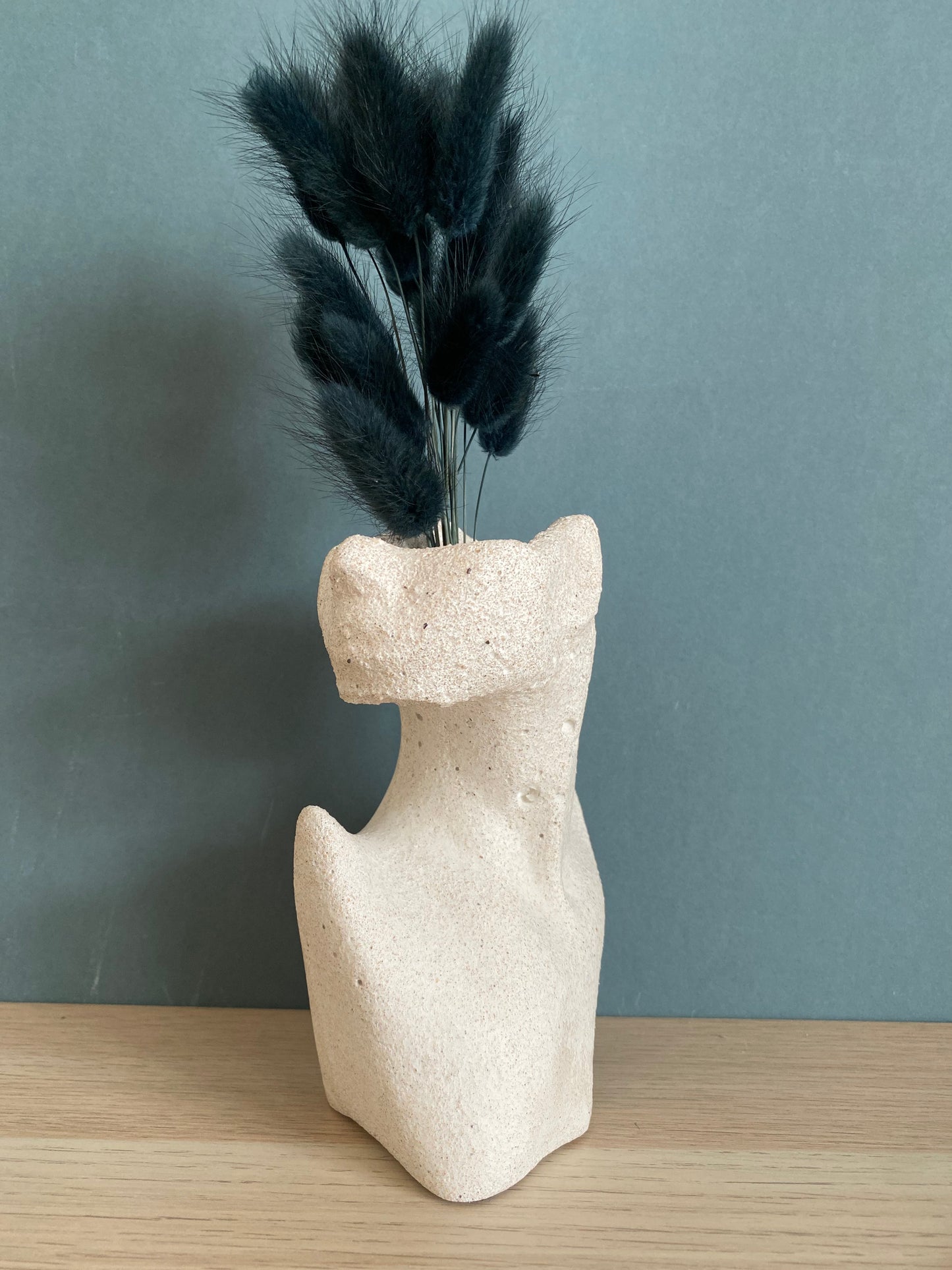 Woman half face stone vase