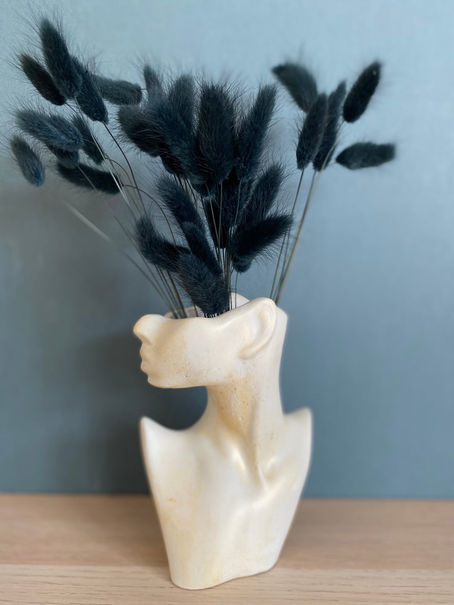 Woman half face stone vase